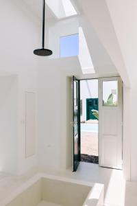 a white bathroom with a tub and a window at Casa Montelongo - Adults Only in La Oliva +19 photos