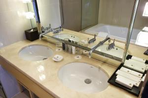 a bathroom with two sinks and a large mirror at Hotel Entra Gangnam in Seoul