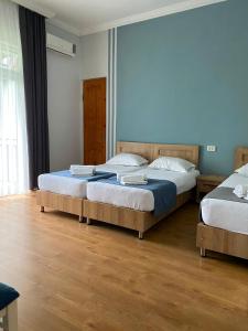 zwei Betten in einem Zimmer mit Holzboden in der Unterkunft жули in Gonio + 19 Fotos