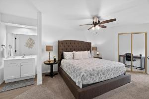 a bedroom with a bed and a sink and a ceiling fan at Birdies & Bikes at Fairway 45 in Bella Vista +16 photos