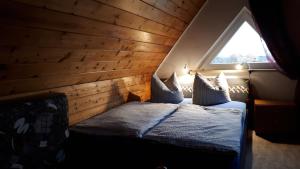 a bedroom with a bed in a room with a window at Haus Haase in Prenzlau