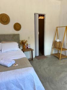 a bedroom with a bed and a door into a room at Yahweh Guriú Kite in Guriú