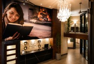 a woman sitting at a counter reading a book at Comfort Inn in Saint-Georges