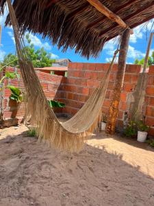 a hammock in front of a brick wall at Yahweh Guriú Kite in Guriú