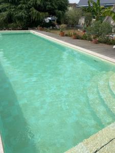 a swimming pool with turquoise blue water at Bonamy's in Saint-Ouen