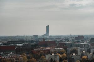 a city skyline with a tall building in the distance at Prize by Radisson, Wroclaw Sky Tower in Wrocław
