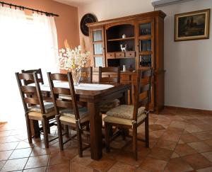 a dining room with a wooden table and chairs at Apartmani Filip i Jakov in Senj