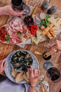 a group of people sitting around a table with food at The Waterhead Inn, Ambleside- The Inn Collection Group in Ambleside