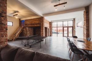 a living room with a ping pong table and a brick wall at Alpine Retreat in Borsa