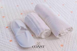 a pair of rolled towels next to a pair of slippers at San Pantaleo Charme in San Pantaleo +36 photos