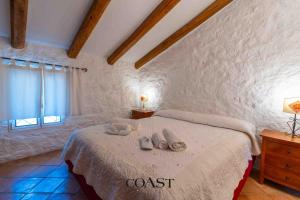 a bedroom with a bed with towels on it at San Pantaleo Charme in San Pantaleo