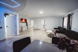 a living room with a couch and a table at Alpine Retreat in Borsa