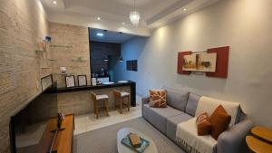 a living room with a couch and a bar at Casa Completa e Confortável para sua Estadia in Ribeirão Preto