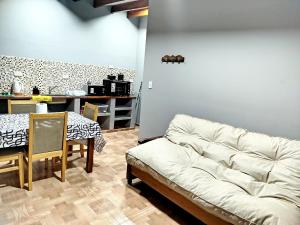 a living room with a white couch and a table at Alojamiento Quilla-Unta in Fiambalá +20 photos