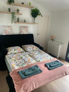 a bedroom with a bed with two towels on it at Bonamy's in Saint-Ouen