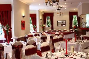 a banquet hall with white tables and chairs in it at Old Rose and Crown Hotel Birmingham in Rubery