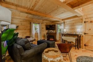 a living room with a couch and a table at Starry Nights in the Smokey Mountains with Hot Tub Pet Friendly Cabin A in Elizabethton