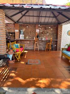 a patio with chairs and a bar in a brick wall at Hotel La Casona Del Valle in Valledupar