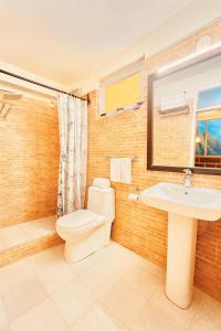 a bathroom with a toilet and a sink at Manu Villa Manali - A Beautiful Cottage towards Snow Capped Mountain in Manāli