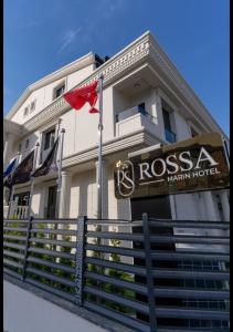 a hotel with a sign in front of a building at Rossa Marin Hotel in Darıca