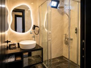 a bathroom with a sink and a shower at Rossa Marin Hotel in Darıca