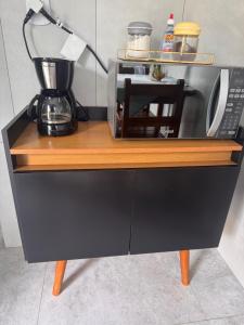 a counter with a microwave and a coffee maker on it at Recanto Catarina in Cunha +13 photos