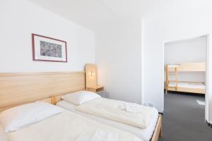 two beds in a room with two bunk beds at Akademiehotel Jena in Jena +40 photos
