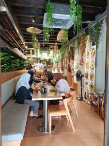 two women sitting at a table in a restaurant at Georgetown Kyash House 23 in George Town