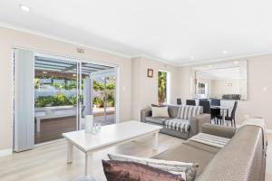 a living room with a couch and a table at Ravens 9A in Bloubergstrand