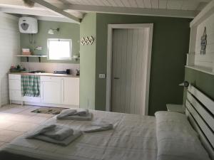 a bedroom with a bed with two towels on it at Villa Ghirardelli in Sirolo