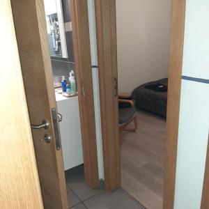 a door leading into a room with a bedroom at Italian stile in Spa