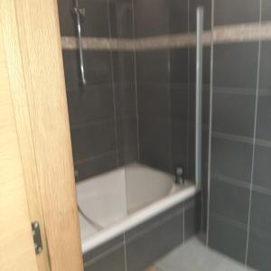 a bath tub in a bathroom with a shower at Italian stile in Spa