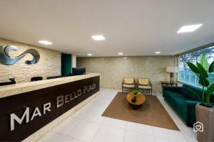 a lobby of a marriott hotel with a green couch at Mar Bello in Ilha da Restinga +75 photos