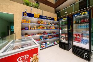 a grocery store aisle with shelves of food and drinks at Mar Bello in Ilha da Restinga