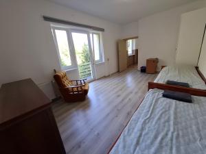 an empty room with a bed and a chair at Pokoje na lato Gdynia in Gdynia