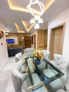 a living room with a glass table and chairs at Declevor Homes in Lekki