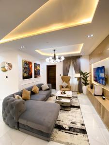 a large living room with a couch and a table at Declevor Homes in Lekki