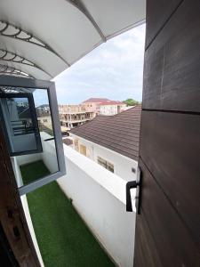 an open door to a balcony with green grass at Declevor Homes in Lekki
