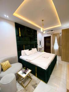 a bedroom with a large bed and a couch at Declevor Homes in Lekki +18 photos