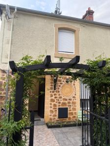 an entrance to a house with a black gate at L'Escapade Normande in Caen +6 photos