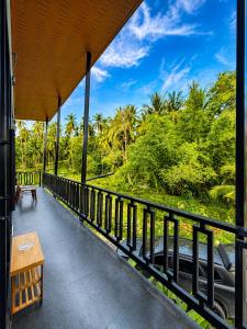 a balcony of a resort with a bench and trees at Jip Studio - 3mn ZenBeach - Garden View in Haad Chao Phao