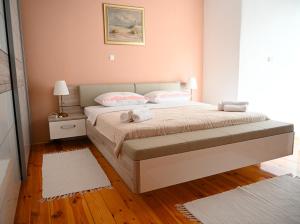 a bedroom with a bed with two pillows at Apartmani Filip i Jakov in Senj