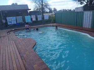 a little girl playing in a swimming pool at Dubbo Farm in Dubbo