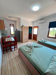 a bedroom with a bed and a table and a desk at Villa Kalaj in Baks-Rrjoll