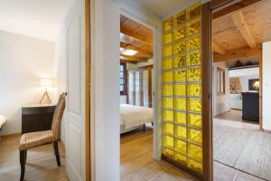 a room with a glass door with a bedroom at Acogedor chalet rústico in Cambre +26 photos