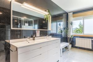 a bathroom with a sink and a mirror at Os Cabaleiros in Mos +21 photos
