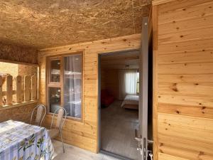 a wooden room with a door leading to a bedroom at Экохаус Hemingway 1 in Borovoye