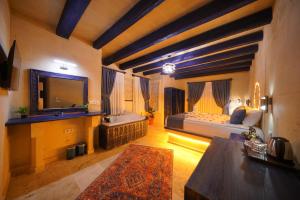 a bedroom with a bed and a sink and a tub at Üçhisar Palace İn Cappadocia in Uçhisar