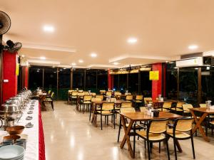 a restaurant with tables and chairs in a room at Girivihar Holiday Club - Pure Veg in Lonavala