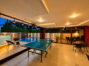 a ping pong table in the middle of a room at Girivihar Holiday Club - Pure Veg in Lonavala +23 photos